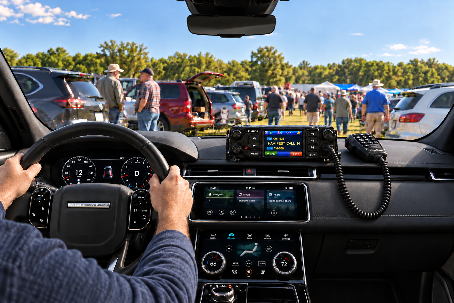 A driver holding the steering wheel in a 2018 Range Rover Velar, looking through the windshield into a grassy hamfest parking field, with radio operators getting out of parked cars and an AnyTone 578 dashboard radio displaying HAM FEST CALL IN.